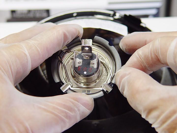 How does the headlight Bulb retainer spring snap back in? ZX Forums